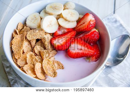 Healthy Breakfast which included cornflakes and oatflakes, yogurt, bananas and strawberries
