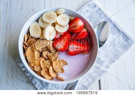 Healthy Breakfast which included cornflakes and oatflakes, yogurt, bananas and strawberries