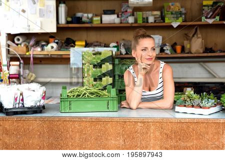 You adult gardener woman working in a garden shop