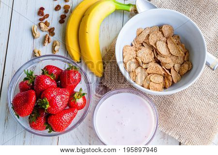Healthy Breakfast which included cornflakes and oatflakes, yogurt, bananas and strawberries