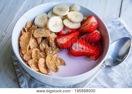 Healthy Breakfast which included cornflakes and oatflakes, yogurt, bananas and strawberries