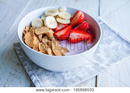Healthy Breakfast which included cornflakes and oatflakes, yogurt, bananas and strawberries
