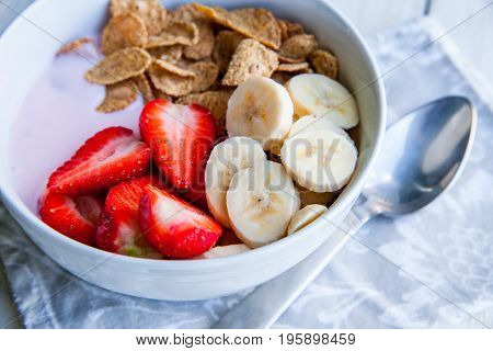 Healthy Breakfast which included cornflakes and oatflakes, yogurt, bananas and strawberries