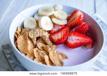 Healthy Breakfast which included cornflakes and oatflakes, yogurt, bananas and strawberries