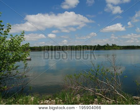 Arbuckle Lake on a bright sunny day, Oklahoma
Blue and white skies reflected in the clear blue waters of Arbuckle Lake, Oklahoma