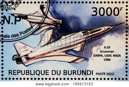 Moscow Russia - July 17 2017: A stamp printed in Burundi shows American experimental supersonic aircraft Grumman X-29 with forward-swept wing (1984) series 