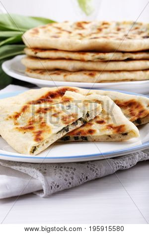 Khychiny - traditional caucasian flatbread filled with сheese and herbs. Flat bread stuffed with feta and wild garlic.