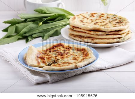 Khychiny - traditional caucasian flatbread filled with сheese and herbs. Flat bread stuffed with feta and wild garlic.