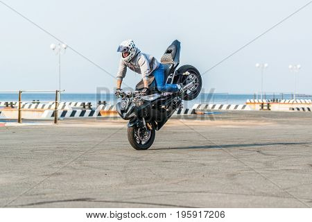 VLADIVOSTOK, RUSSIA - October 05, 2013: Stunt motorcycle rider performing at a local motorcycle show.