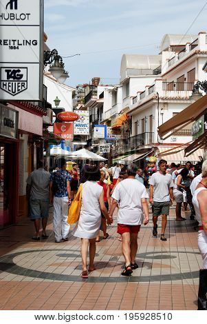 TORREMOLINOS, SPAIN - SEPTEMBER 3, 2008 - Tourists walking along Calle San Miguel shopping street in the old town Torremolinos Malaga Province Andalusia Spain Western Europe, September 3, 2008.