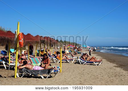 MARBELLA, SPAIN - SEPTEMBER 12, 2008 - Tourists relaxing on Playa de la Vibora beach Elviria Marbella Malaga Province Andalusia Spain Western Europe.