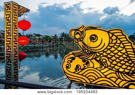 Hoi An city lights and the Thu Bon River in Vietnam at night.