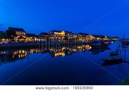 Hoi An city lights across the Thu Bon river in Vietnam