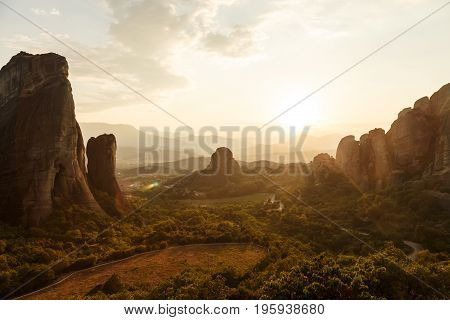 Breathtaking view of rocks of Meteora at sunset, Greece. Geological formations of big rocks with Monasteries at the top of them