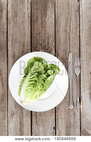 Top View Of Fresh Letuce Salad On Plate With Cutlery On Wooden Table, Healthy Eating Concept