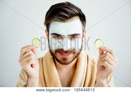 A portrait of a man with a clay mask