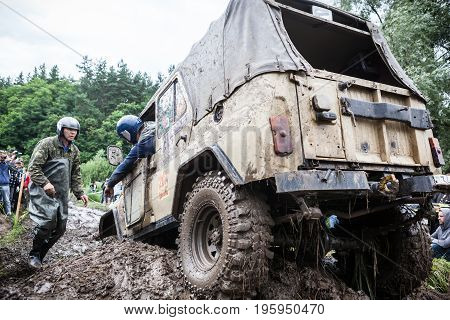 LUBOTIN UKRAINE - JULY 23 2016: RFC Ukraine Wild Boar Challenge 2016. Team on Uaz 469 setting a recovery sand tracks to overcome a hard pit.
