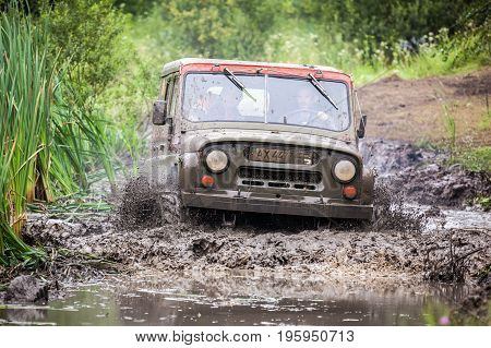 LUBOTIN UKRAINE - JULY 23 2016: RFC Ukraine Wild Boar Challenge 2016. Custom built Off-road Trophy UAZ 469 in the swamp at high speed.