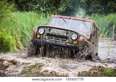 LUBOTIN UKRAINE - JULY 23 2016: RFC Ukraine Wild Boar Challenge 2016. Custom built Off-road Trophy UAZ 469 in the swamp at high speed.