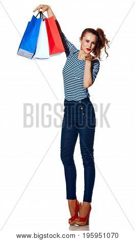 Shopping. The French way. Full length portrait of smiling trendy woman with shopping bags of the colours of the French flag isolated on white blowing air kiss