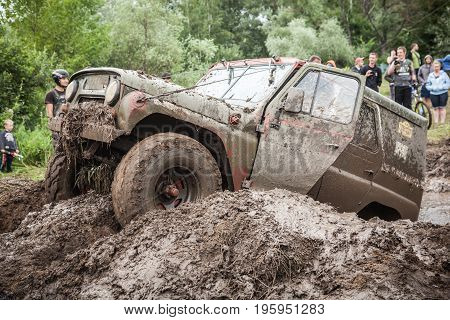 LUBOTIN UKRAINE - JULY 23 2016: RFC Ukraine Wild Boar Challenge 2016. Custom built Off-road Trophy UAZ 469 passing mud pit.