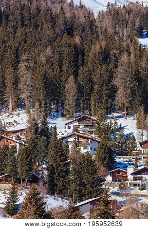 Davos, Switzerland - 26 January, 2017: buildings of the town of Davos on the slope of a mountain. Davos is an alpine town in the Swiss canton of Graubunden, known for the annual World Economic Forum taking place there.
