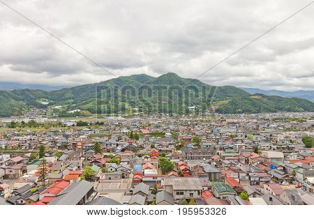 KAMINOYAMA JAPAN - MAY 28 2017: View of Sankichiyama Mount and Kaminoyama City from donjon of Kaminoyama Castle. Modern Kaminoyama was established in 1889 and was elevated to city status in 1954