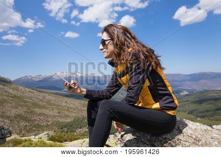 Side Woman Typing Mobile On Top Of Mountain