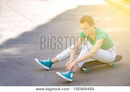 Beautiful girl rides on a highway on Longboard scenic street. Solar toning. Close-up portrait. Healthy lifestyle.