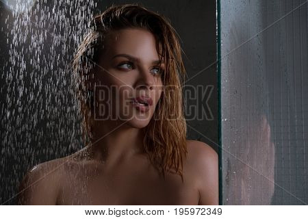 Young pretty girl enjoying shower studio shot