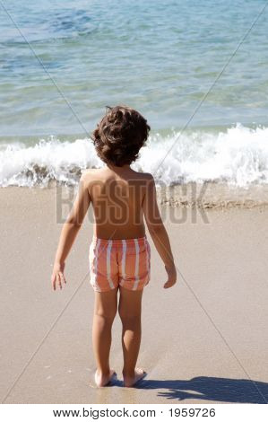 Boy Playing In The Beach