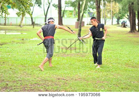 PUKED,THAILAND - AUGUST 28: Master trick of ancient fighter on August 28, 2011 in Puked Thailand.
 Master show how to trick of fight with swords.