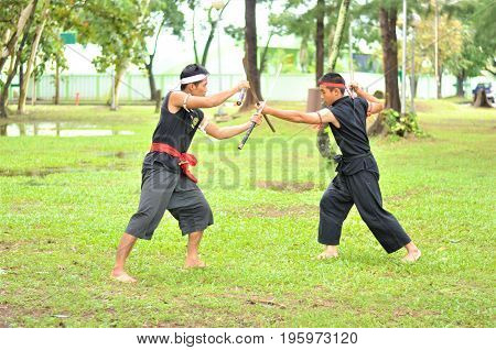 PUKED,THAILAND - AUGUST 28: Master trick of ancient fighter on August 28, 2011 in Puked Thailand.
 Master show how to trick of fight with swords.