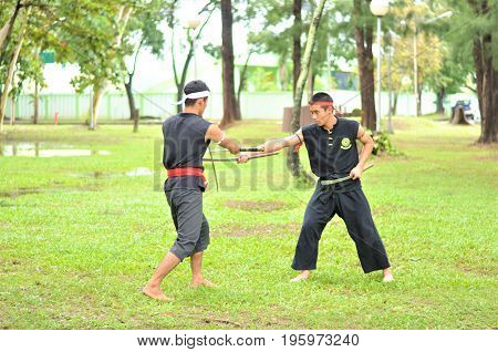 PUKED,THAILAND - AUGUST 28: Master trick of ancient fighter on August 28, 2011 in Puked Thailand.
 Master show how to trick of fight with swords.