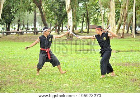 PUKED,THAILAND - AUGUST 28: Master trick of ancient fighter on August 28, 2011 in Puked Thailand.
 Master show how to trick of fight with swords.