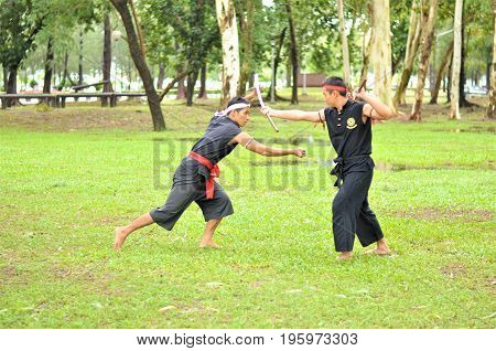 PUKED,THAILAND - AUGUST 28: Master trick of ancient fighter on August 28, 2011 in Puked Thailand.
 Master show how to trick of fight with swords.