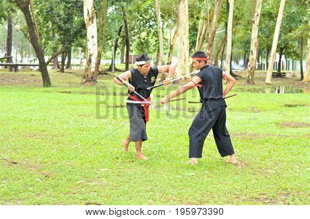 PUKED,THAILAND - AUGUST 28: Master trick of ancient fighter on August 28, 2011 in Puked Thailand.
 Master show how to trick of fight with swords.