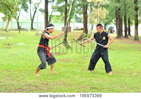 PUKED,THAILAND - AUGUST 28: Master trick of ancient fighter on August 28, 2011 in Puked Thailand.
 Master show how to trick of fight with swords.