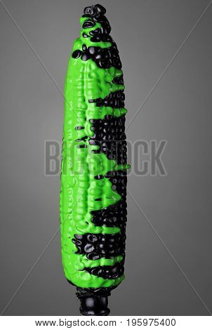 Black Corn With Pouring Green Toxic Paint On Gray Background. Fashion Food Concept.creative.