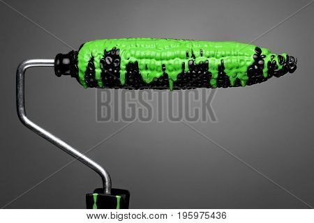 Paint Roller Black Corn With Pouring Green Toxic Paint On Gray Background. Fashion Food Concept.crea