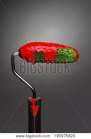Paint Roller Cucumber With Pouring Red Paint On Gray Background. Fashion Food Concept.creative Adver