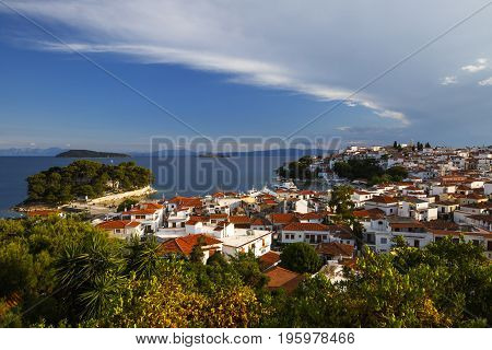 View of the old harbour on Skiathos island and Euboea in the distance, Greece.