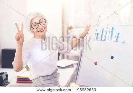 Doing the job. Busy wise wonderful woman enjoying doing her work while analyzing and comprehending analytic data