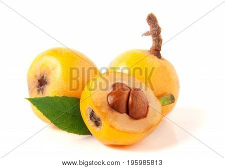 Ripe loquat or Eriobotrya japonica with leaf isolated on white background.