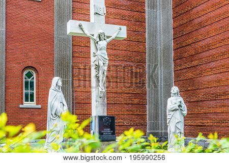 Montreal Canada - May 27 2017: Statue of Jesus Christ crucifixion at Notre Dame de la Defense church in Little Italy Plateau neighborhood in city in Quebec region