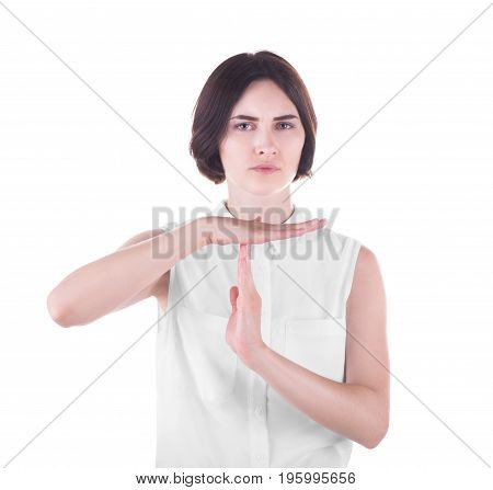 Serious and strict business-woman is showing break sign, isolated on a white background. An elegant and young lady showing timeout gesture. Timeout signal hand. Positive and negative human emotions.