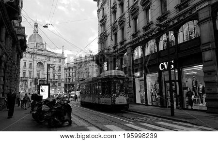 MILAN, ITALY - October 15, 2015: The black and white landscape of street and beautiful city with the tram in Milan, Italy.