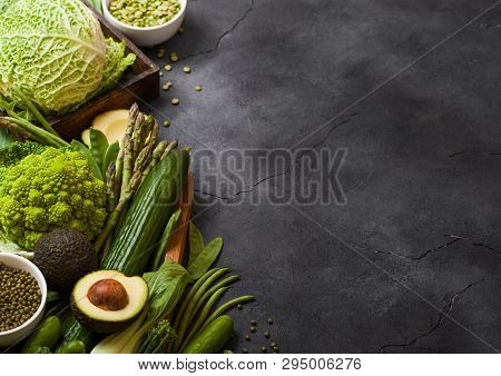 Assorted Green Toned Raw Organic Vegetables On Dark Background. Avocado, Cabbage, Broccoli, Cauliflo