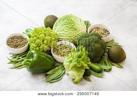 Assorted Green Toned Raw Organic Vegetables On White Background. Avocado, Cabbage, Broccoli, Caulifl