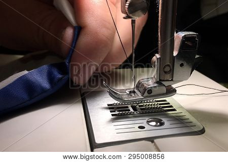 Worker Stitches Cloth On Sewing Machine. Cratches The Thread On The Fabric.